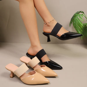 Sculpted mid-heel pointed toe mule sandals in black and apricot patent leather with elastic straps.