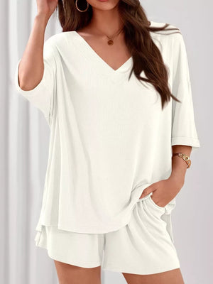 Ivory V-neck two-piece loungewear set with relaxed fit top and shorts.