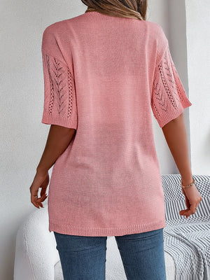 Open-knit chevron sleeve cardigan in burnt coral acrylic with short sleeves.