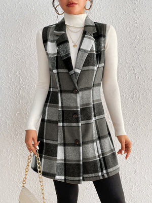 Sleeveless plaid blazer dress in black and grey, buttoned A-line cut, worn with a white turtleneck.