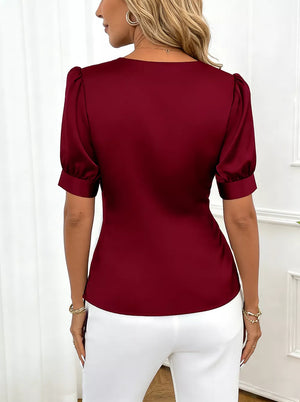 Burgundy satin blouse with short puff sleeves and a V-neckline.