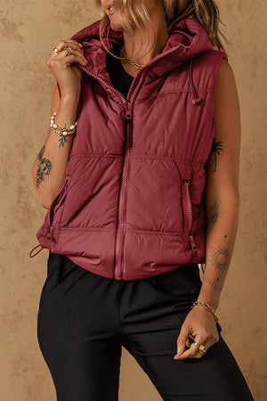 Burgundy quilted hooded puffer vest with zip front, pockets, and drawcord hem.