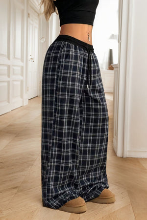 Black plaid palazzo lounge trousers with a drawstring waist and wide leg.