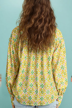 Yellow green floral ruffle yoke button-down blouse with long sleeves.