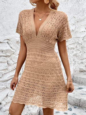 Khaki openwork knit beach mini dress with V-neck and smocked waist.