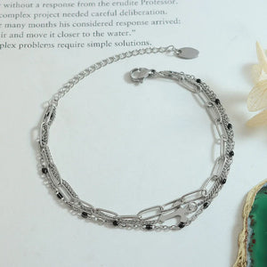 Silver layered chain and bead bracelet trio with cross charm