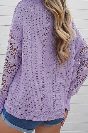 Lavender openwork knit sweater with lace sleeves and intricate stitch patterns.