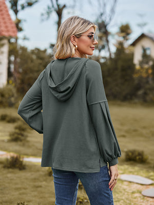Army green ribbed hoodie with balloon sleeves and a hood.