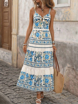 Maxi dress with blue floral print, tie-front neckline, and tiered skirt.