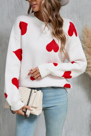 White acrylic knit jumper with red intarsia hearts, crew neck, long sleeves.
