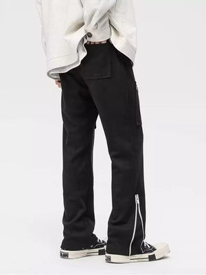 Black relaxed fit sweatpants with zipper pockets and ankle zippers.