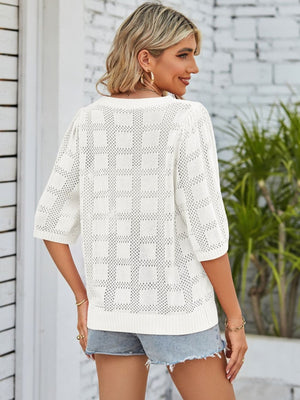 White openwork box stitch knit top with short sleeves and a crew neck.