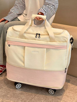 Cream and pink large rolling duffel bag with dual handles and wheels