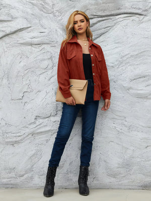 Textured corduroy button-up jacket in amber with two chest pockets and a collared neckline.