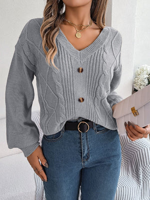 Gray cable knit button-front cardigan with V-neck and balloon sleeves.