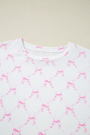 White loungewear set with pink bow print and scalloped edges.