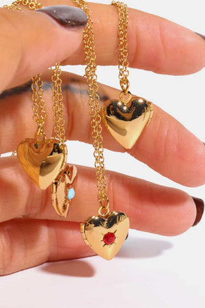 Gold heart locket necklaces with gemstone details, one open with turquoise.