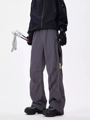 Men's gray loose fit cargo sweatpants with contrast stitching and yellow zipper detail.