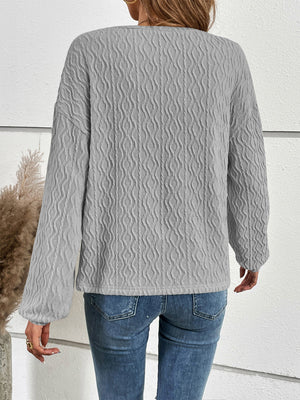 Textured charcoal blouson sleeve henley top with button detail
