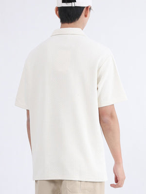 Textured polo shirt in Desert Color with short sleeves and a collar.