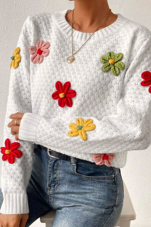 White knit sweater with colorful crochet floral appliques, crew neck, long sleeves.