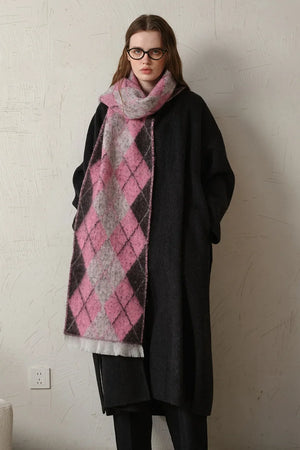 Argyle knit scarf in pink, grey, and black with fringe detail.