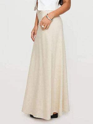 Beige bias-cut maxi skirt with a flowing silhouette.