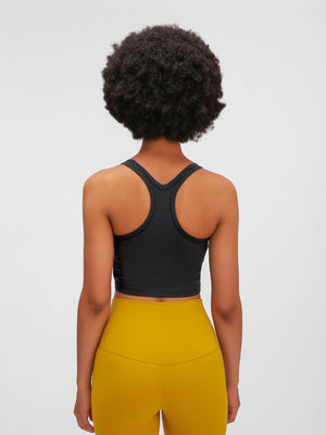 Black racerback crop tank top with a textured fabric detail.