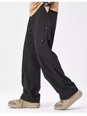 Black relaxed fit cargo sweatpants with snap-button pockets and a wide leg.