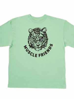 Oversized graphic tee in Gum Leaf green with a black tiger face and Muscle Friends text.