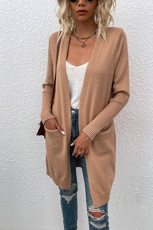 Khaki open-front cardigan with ribbed cuffs and pockets, styled with a white tank and ripped jeans.