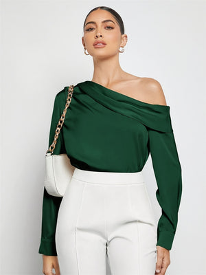 Dark green silk-effect blouse with draped asymmetric neckline and long sleeves.