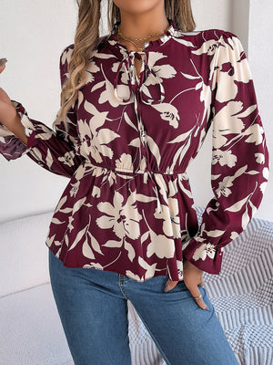 Burgundy floral peplum blouse with ruffled neck and tie detail