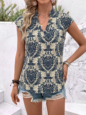 Ornate cap sleeve blouse with notch neckline in blue and beige damask print.