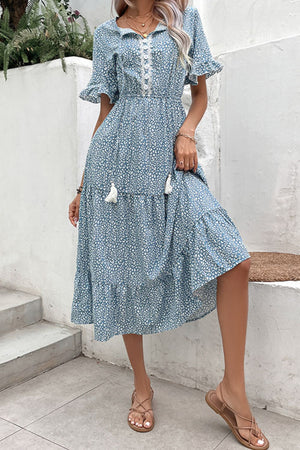 Light blue floral midi dress with tiered skirt, lace trim, and tassel details.