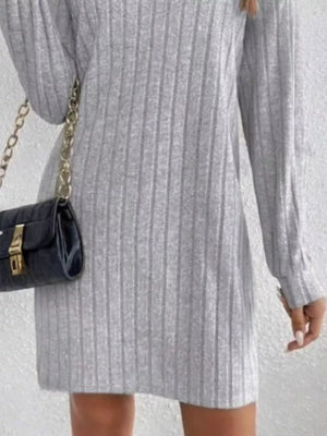 Light gray ribbed turtleneck mini dress with long sleeves, styled with a black crossbody bag.