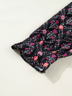 Black cotton blouse with pink floral print and ruffled bracelet sleeves.