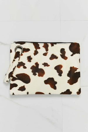Brown and cream cowhide print clutch bag with wristlet strap