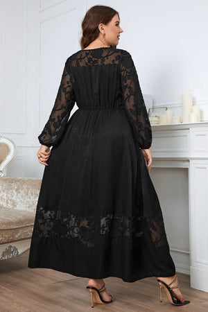 Black maxi dress with sheer embroidered sleeves and hem, A-line cut.