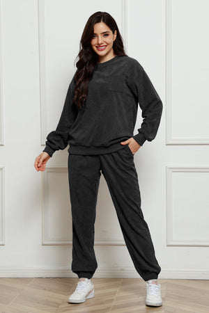 Dark Gray corduroy lounge set with crew neck sweatshirt and pocket detail, and matching pants.