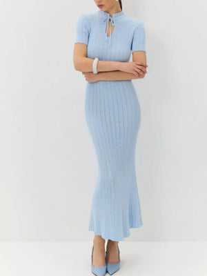 Light blue knit mermaid dress with short sleeves and tied neckline.
