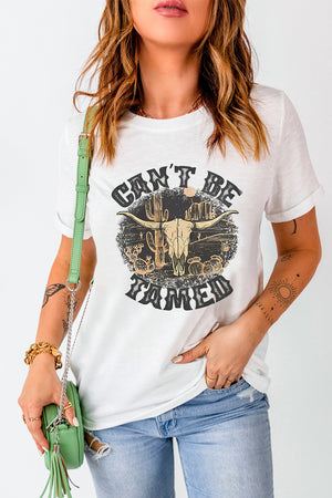 White cotton blend graphic tee with "Can't Be Tamed" text and bull skull desert graphic