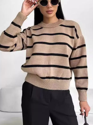 Taupe knit sweater with black stripes, round neck, long sleeves, and ribbed cuffs and hem.