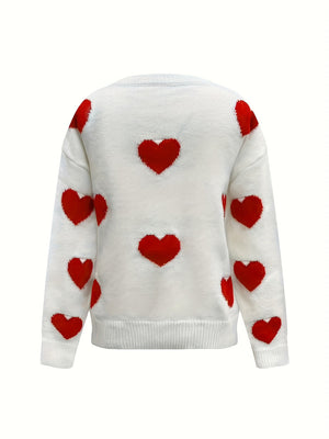 White oversized knit crewneck sweater with all-over red heart pattern and drop sleeves.