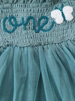 Sea blue smocked baby bodysuit with embroidered "one" and butterfly detail, and tulle skirt.