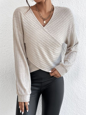 Cross-front ribbed knit top in Dust Storm with blouson sleeves and a V-neck.