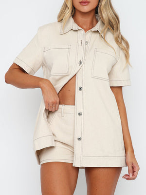 Cream utility set with contrast stitching, button front shirt, and shorts.