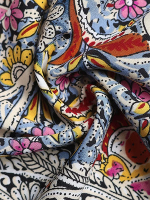 Paisley print midi dress with tie neck, featuring a colorful floral and paisley pattern.