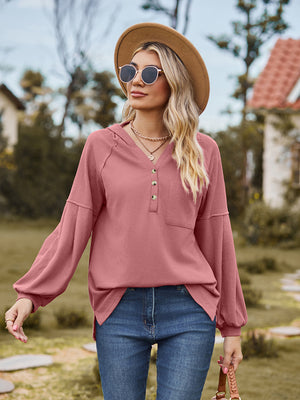 Ribbed balloon sleeve hoodie in watermelon pink with buttoned henley neckline and chest pocket.