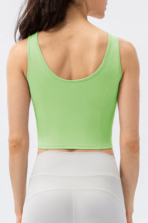 Green active crop top with sculpted seams and scoop neckline.